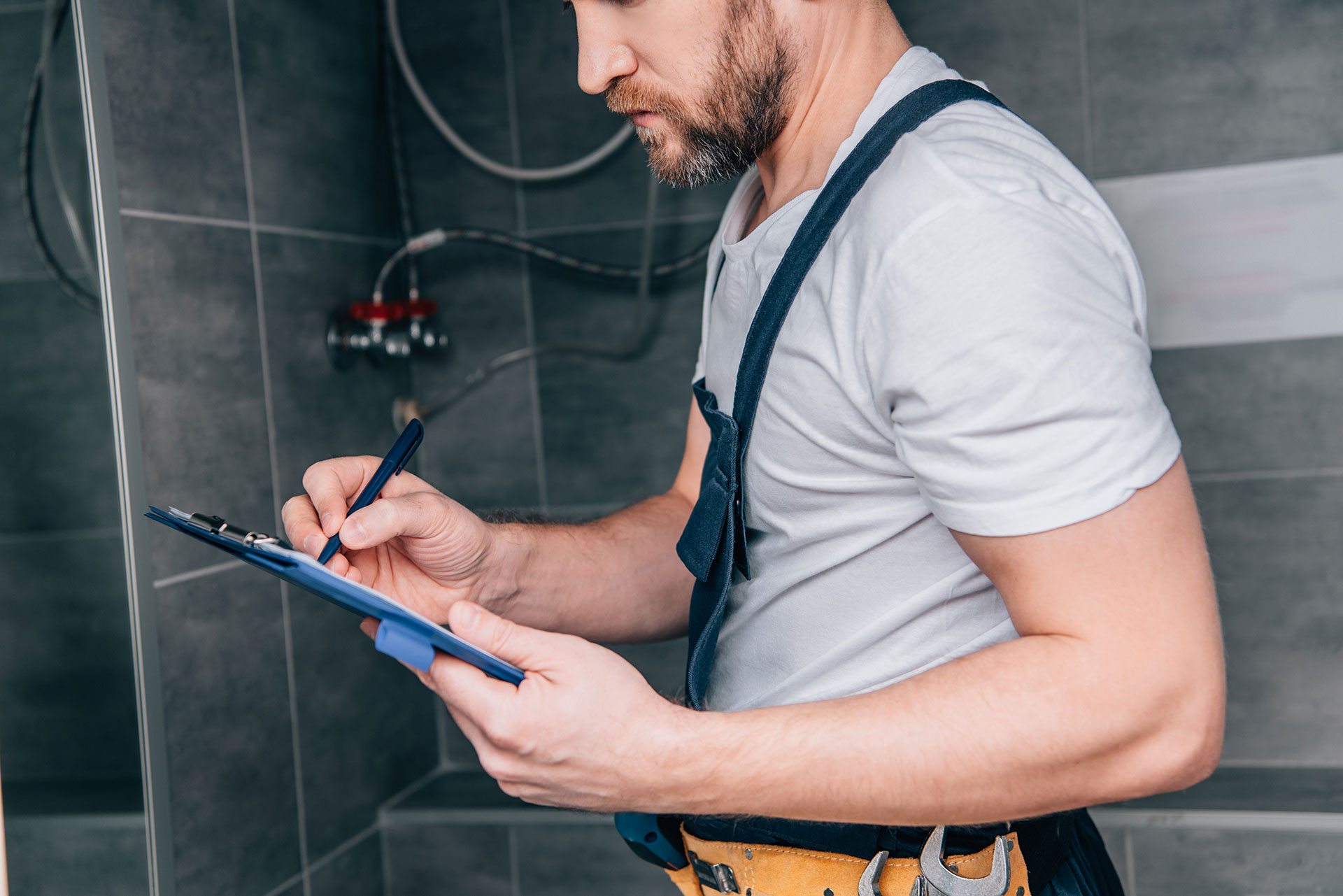 plumber with checklist doing maintenance