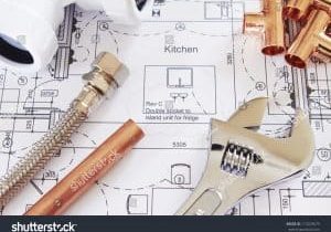 stock-photo-plumbing-tools-arranged-on-house-plans-113229679